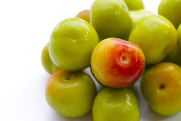 Fresh green plum on white background