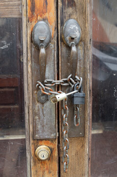 Fortified: Strong Chains and Padlocks Guard the Entrance of an Abandoned Building
