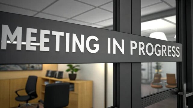 Meeting in Progress: The sign "Meeting in Progress" on a glass door indicates an active business meeting, with a glimpse inside the office space hinting at the ongoing discussion.