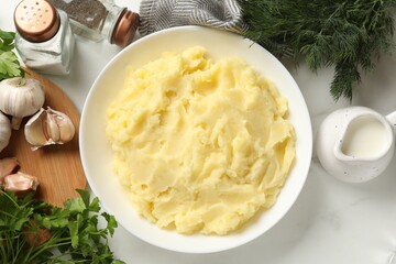Delicious mashed potato served on white table, flat lay