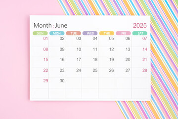 June 2025 calendar page on pink and rainbow background.