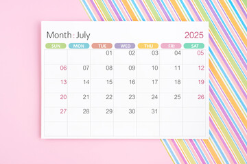 July 2025 calendar page on pink and rainbow background.