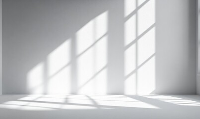 Fototapeta premium Bright Sunlight Casting Elegant Shadows on White Wall and Floor Creating a Minimalist Atmosphere in Modern Interior Space