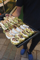 Fresh turkish delight rolls displayed at a bustling market in the afternoon