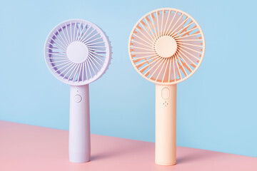 Small mini fans on blue and pink background close-up. © TATIANA KIM