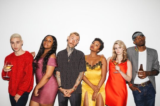 Group of diverse young adults posing. Casual, stylish, diverse group. Men and women, various ethnicities. Social, trendy, diverse gathering. Diverse young friends celebrating and partying. - Powered by Adobe