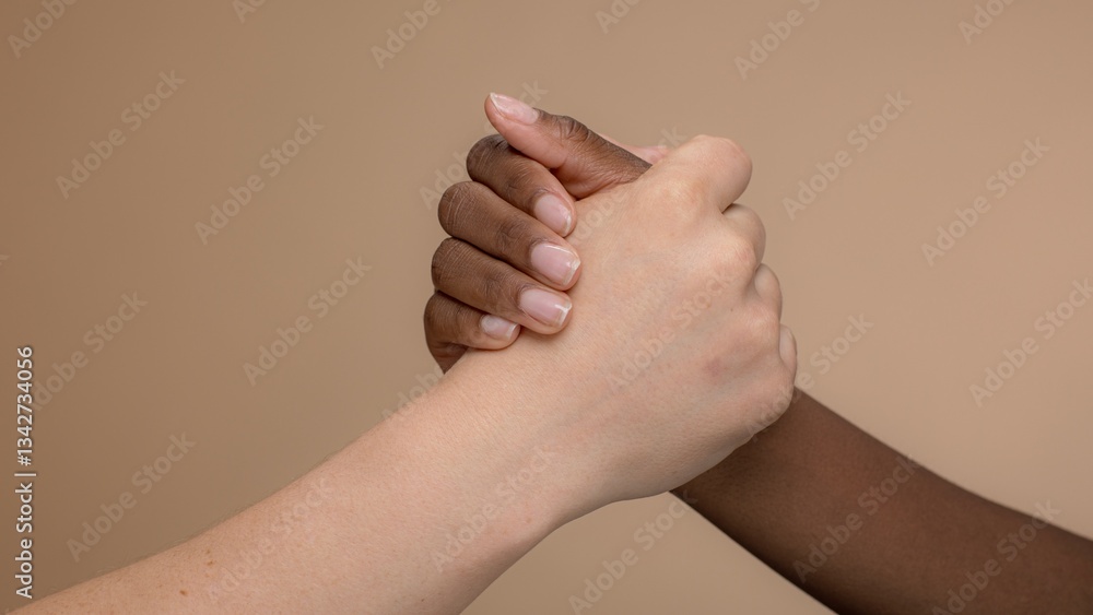 Poster close-up of two diverse hands clasped together. hands in unity, symbolizing friendship and support. 