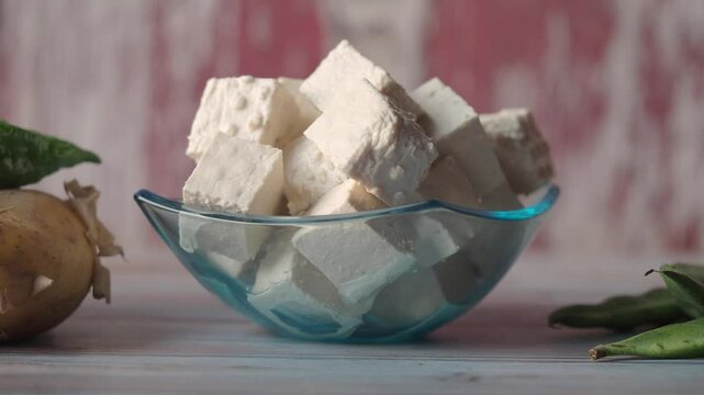 Delicious vegan tofu in a clear bowl on a wooden table