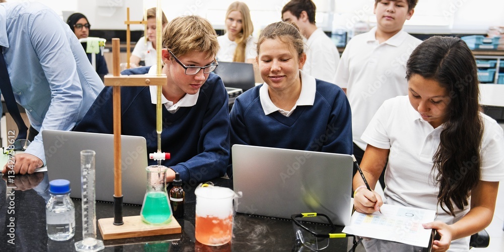 Poster students in a science class working on experiments. diverse group, including young men and women, fo