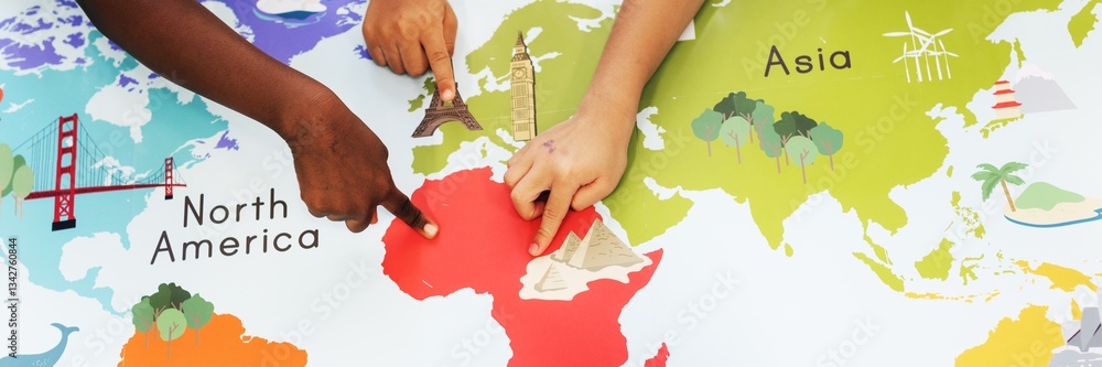 Poster children's hands pointing at a colorful world map. diverse hands on map. exploring continents on a m