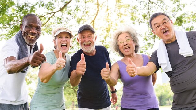 Diverse group of happy seniors people exercise outdoors give thumbs up. Diverse senior men and women enjoy exercise in park, give thumbs up. Happy senior, active outdoor lifestyle, diverse group