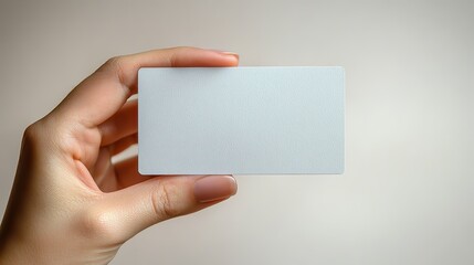 Obraz premium An open hand holds a blank business card, modern and unique, against a white background