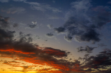 Dramatic sunset sky HDR composite with spectrum of colors across the sky ranging from yellow to deep blue and purple
