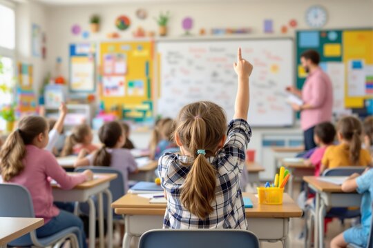 Classroom with students raising hands to participate in lesson.