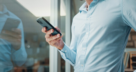Hands, smartphone and texting by window in office with reflection, contact and notification at startup. Business person, chat and click on mobile app, social media and networking at creative agency