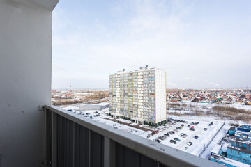 the balcony of an apartment on the upper floors of an apartment building