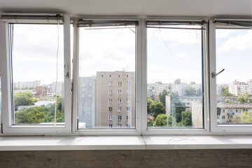 the balcony of an apartment on the upper floors of an apartment building