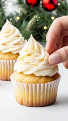 Close-up of skilled baker's hands artfully decorating colorful cupcakes with creamy icing and toppings for a treat