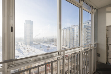 the balcony of an apartment on the upper floors of an apartment building