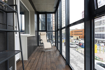 the balcony of an apartment on the upper floors of an apartment building