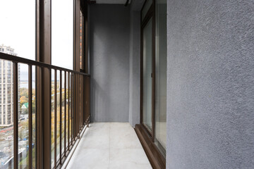 the balcony of an apartment on the upper floors of an apartment building