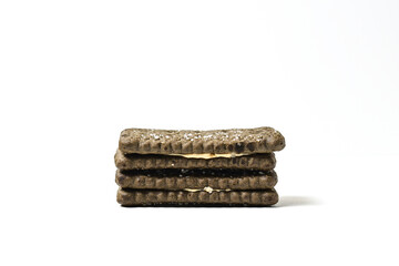 Photo of 2 or two black biscuit with peanut cream and sugar on the topping isolated on white background. Stack.