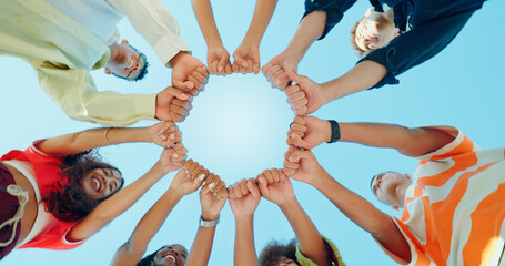 Blue sky, below and hands of people in circle for support, solidarity and community outdoors....