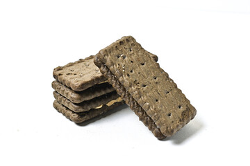 Photo of 3 or three black biscuit with peanut cream and sugar on the topping isolated on white background. Stack.