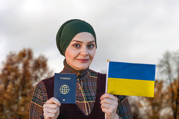 Muslim Woman Holding Passport and Flag of Ukraine
