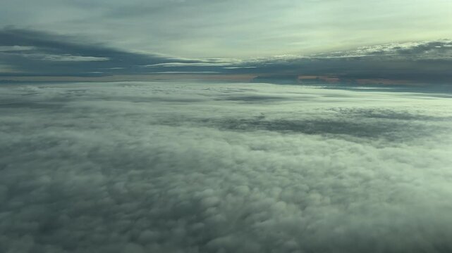 Immersive pilot&rsquo;s perspective POV FPV flying between layers of ethereal clouds at dawn. An aerial footage taken from inside a jet cokpit. 4K