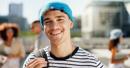 Happy, backpack and portrait of student in city for travel to university, college and school campus. Smile, confident and man relax in urban town for education, learning and knowledge outdoors