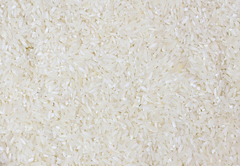 Dry Uncooked White Rice Background - Top View, Flat Lay. Scattered Raw Long Grain Rice. Asian Cuisine and Culture. Healthy Eating Ingredients. Diet Food. Calories.