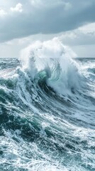 Fototapeta premium Mechanical energy physics motion concept, Dynamic ocean wave crashing with frothy spray under a cloudy sky.