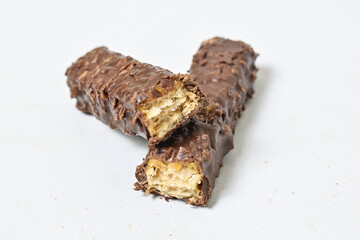 Photo of stack chocolate bar filled with wafer isolated on white background. Wafer chocolate caramel. Broken in half. Close up.