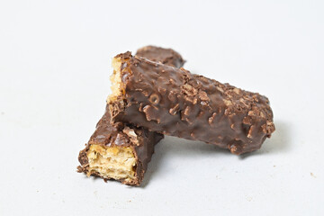 Photo of stack chocolate bar filled with wafer isolated on white background. Wafer chocolate caramel. Broken in half. Close up.
