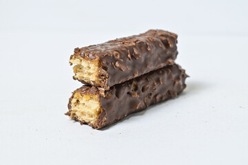 Photo of stack chocolate bar filled with wafer isolated on white background. Wafer chocolate caramel. Broken in half.