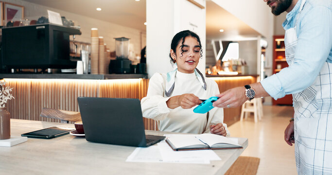 Woman, customer and waiter with pos machine at cafe for payment, NFC transaction or wireless atm. Freelance person, purchase and laptop with credit card for fintech, tap or checkout at coffee shop