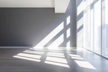 Obraz premium Bright sunlight casting shadows in a modern empty room with large windows