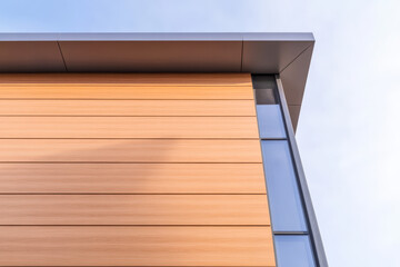 Fototapeta premium Modern architecture with wooden facade in daylight showcasing sleek design elements