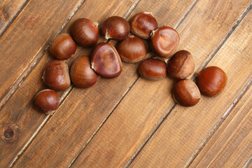 raw chestnuts on wooden background