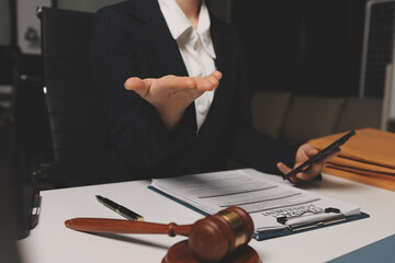 Judge gavel with Justice lawyers having team meeting at law firm background. Concepts of Law and...