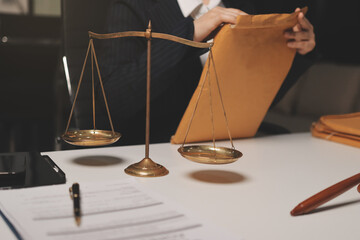 Judge gavel with Justice lawyers having team meeting at law firm background. Concepts of Law and...