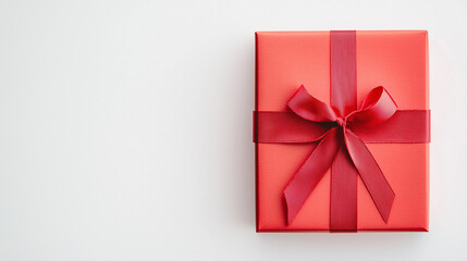 Wrapped in Anticipation: A vivid red gift box, adorned with a matching ribbon and bow, poised against a pristine backdrop.