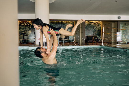 girl swimming in indoor swimming pool at hotel