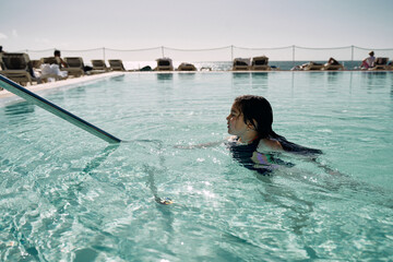 girl in outdoor swimming pool at hotel