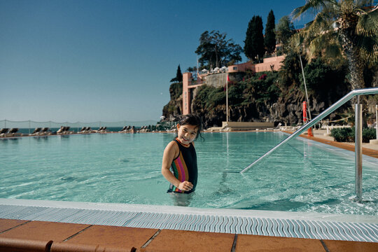 girl in outdoor swimming pool at hotel
