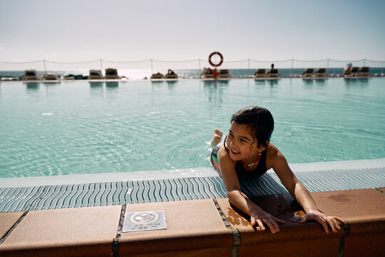 girl in outdoor swimming pool at hotel