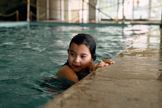 girl swimming in indoor swimming pool