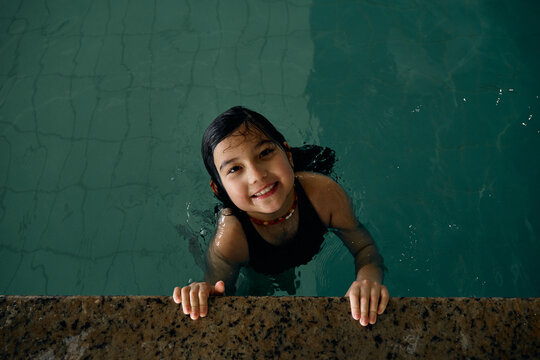 girl swimming in indoor swimming pool at hotel
