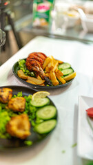 Chef preparing traditional indian tandoori chicken with french fries
